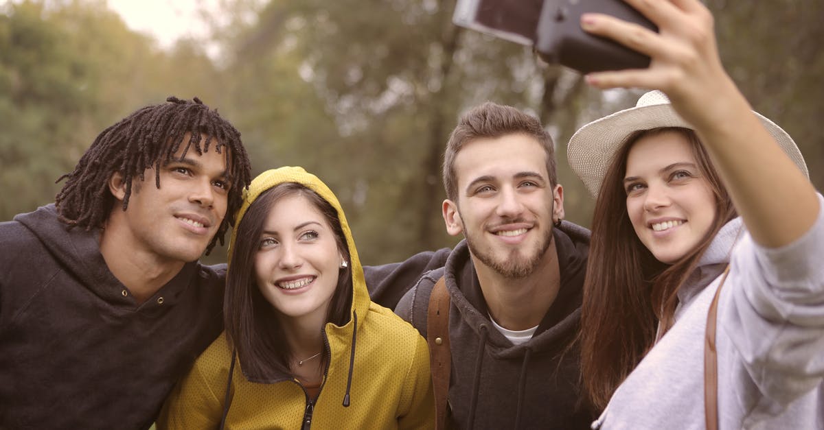 Why do the Pokemon always have three pawprints? - Happy diverse friends taking selfie in park
