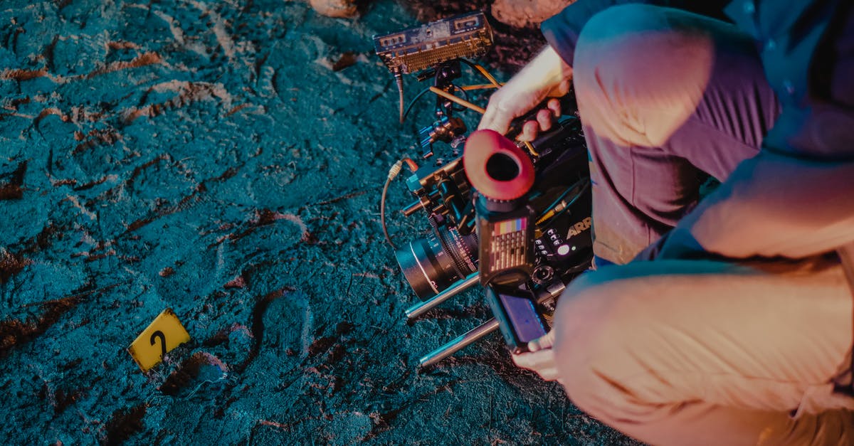 Why does apprehending a civilian shooter make the police shoot at me? - High angle of crop unrecognizable investigators with professional equipment photographing evidence at crime scene Why does apprehending a civilian shooter make the police shoot at me? - High angle of crop unrecognizable investigators with professional equipment photographing evidence at crime scene