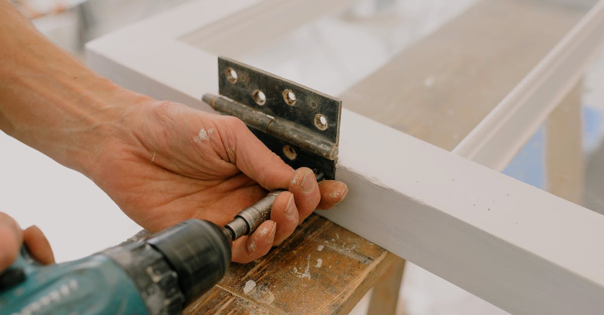 Why does Coop Mode not work for my Assembly? - Crop unrecognizable worker drilling metal hinge on white window frame during house renovation