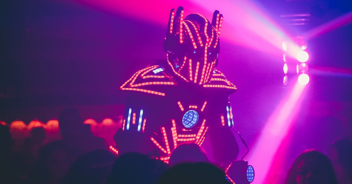Why does everyone sound like a robot in ps4 party chat - Anonymous person in illuminated futuristic costume of robot performing show on stage of modern nightclub with neon illumination