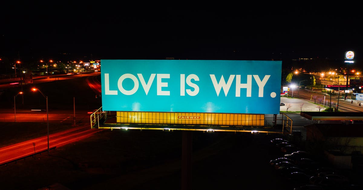 Why does Isaac glow on spiderwebs? - Blue billboard saying Love is why placed on road surrounded by cars and street lights against black night Why does Isaac glow on spiderwebs? - Blue billboard saying Love is why placed on road surrounded by cars and street lights against black night