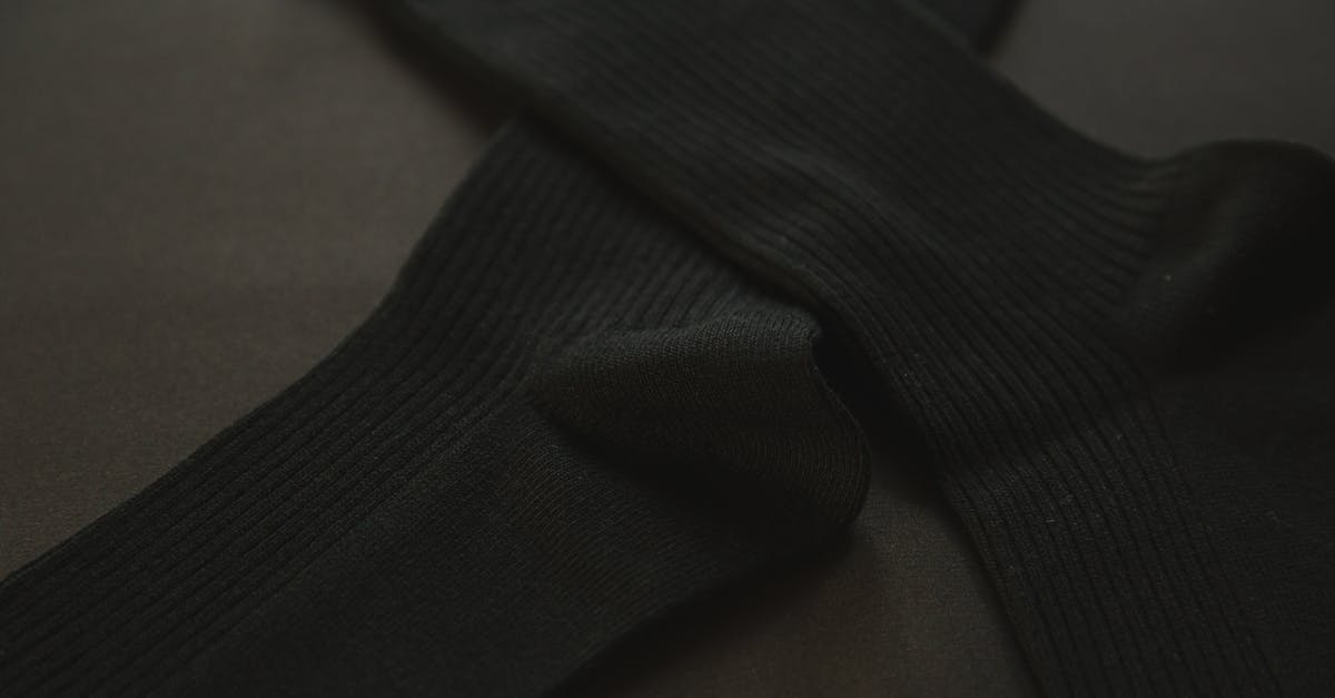 Why does it take so long to get an item? - From above of short stocking for wearing on legs placed on black background Why does it take so long to get an item? - From above of short stocking for wearing on legs placed on black background