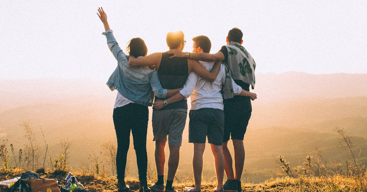 Why does my friend have fewer Pokémon than me? - Anonymous friends standing together at sunset in mountains