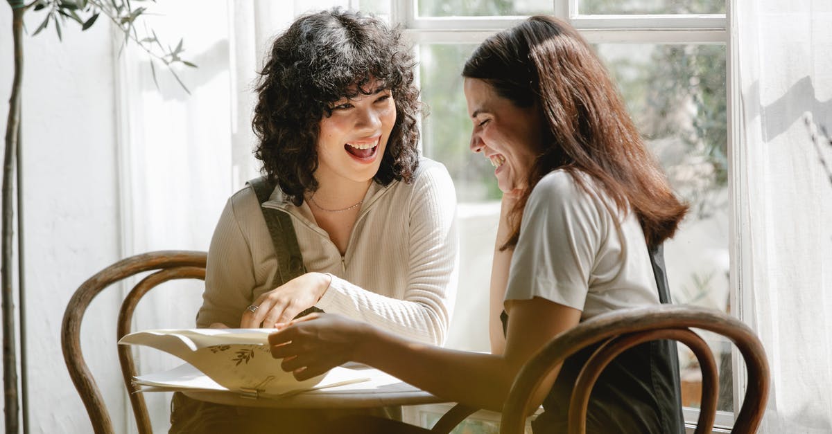 Why does my hoverpad flip over? - Laughing multiracial female colleagues wearing uniform flipping pages of papers while discussing work together Why does my hoverpad flip over? - Laughing multiracial female colleagues wearing uniform flipping pages of papers while discussing work together