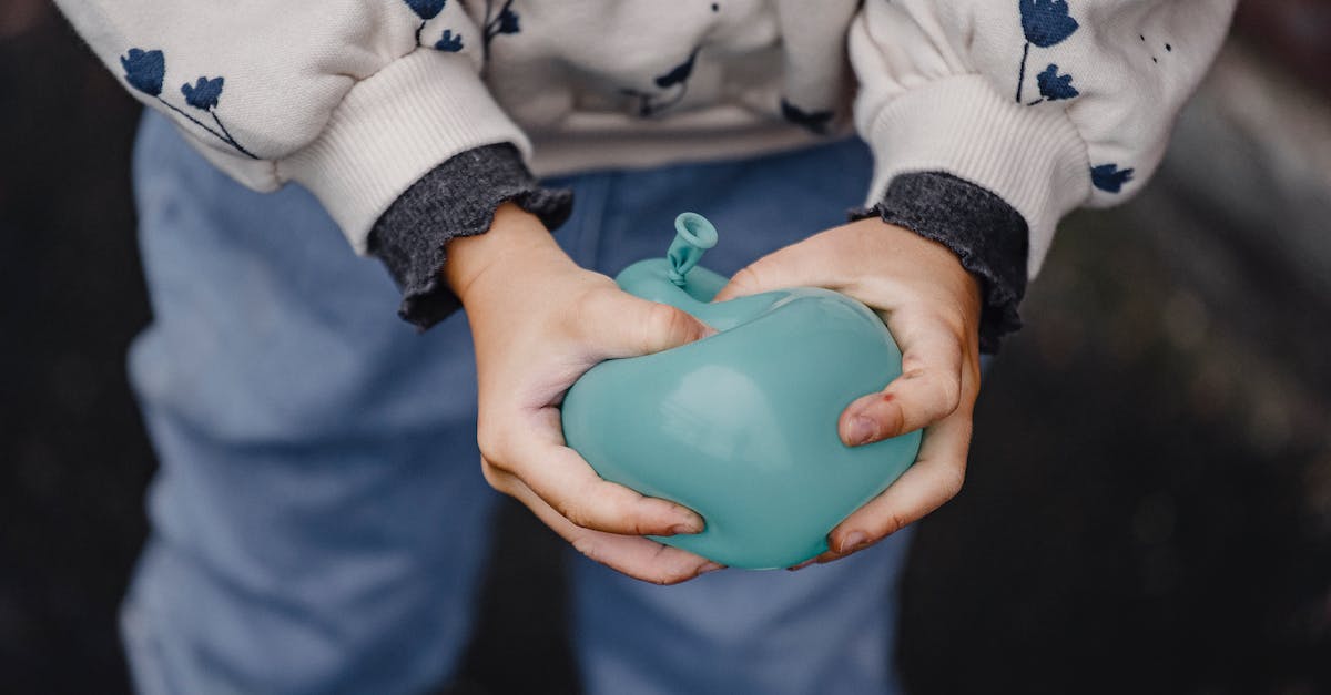 Why does my Minecraft launcher keep crashing when I press play? [duplicate] - From above of crop anonymous kid in casual clothes with ornament pressing blue balloon in daylight