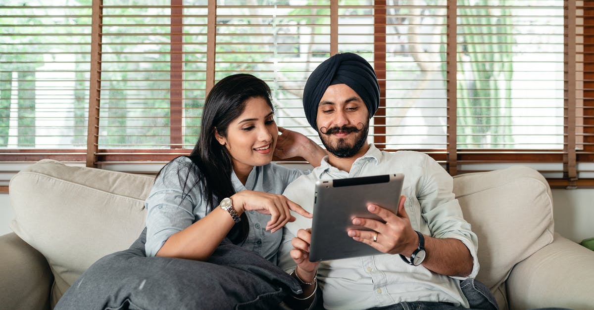 Why does my Pokemon Go app close back to homescreen every time I select a starter? - Content Indian woman and man in turban resting on cozy couch in living room and sharing tablet Why does my Pokemon Go app close back to homescreen every time I select a starter? - Content Indian woman and man in turban resting on cozy couch in living room and sharing tablet