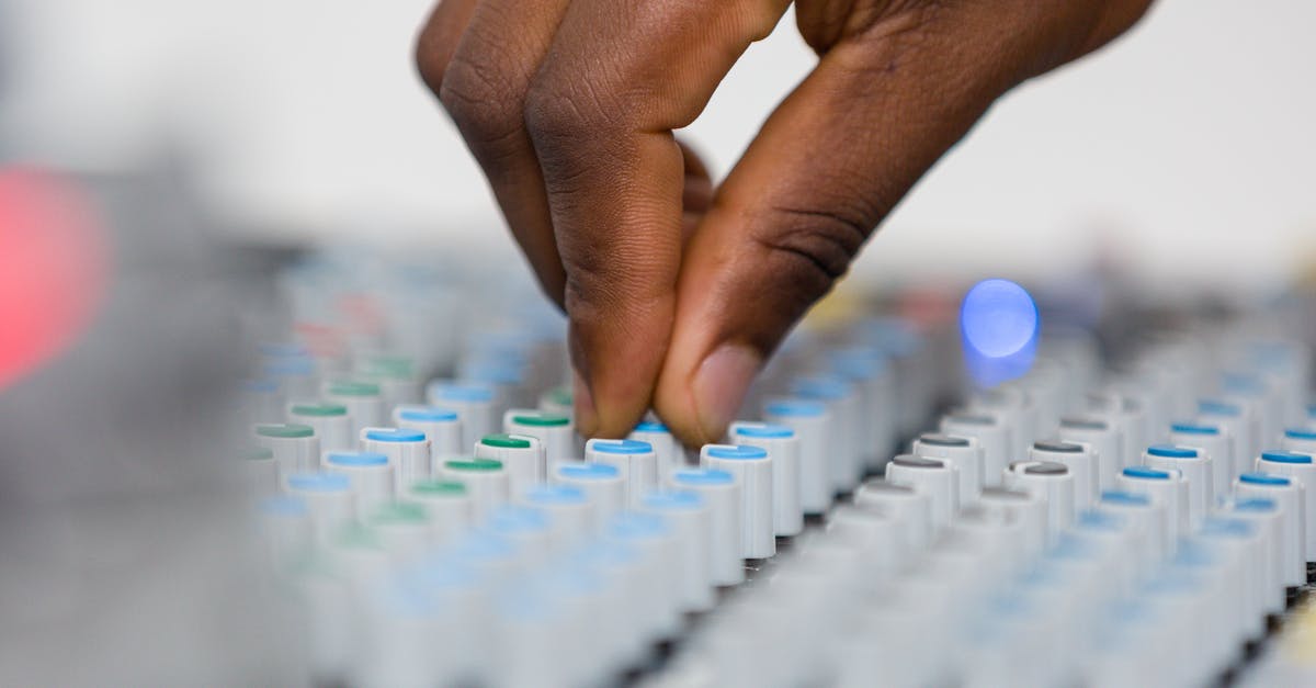 Why does my sound keep playing after I close the game? - Person Playing White and Blue Audio Mixer