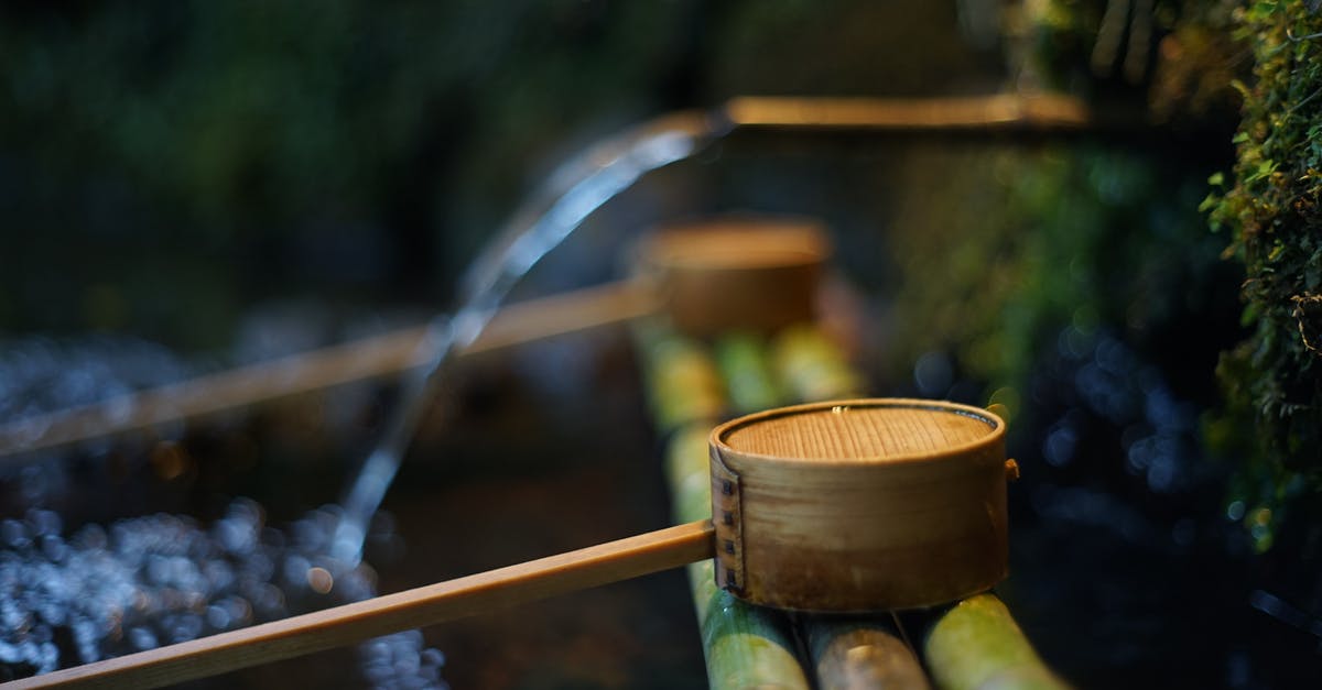 Why does water not flow to the right in this pipe? - Natural spring with clean water near bamboo pipes and wooden dippers in summer park Why does water not flow to the right in this pipe? - Natural spring with clean water near bamboo pipes and wooden dippers in summer park