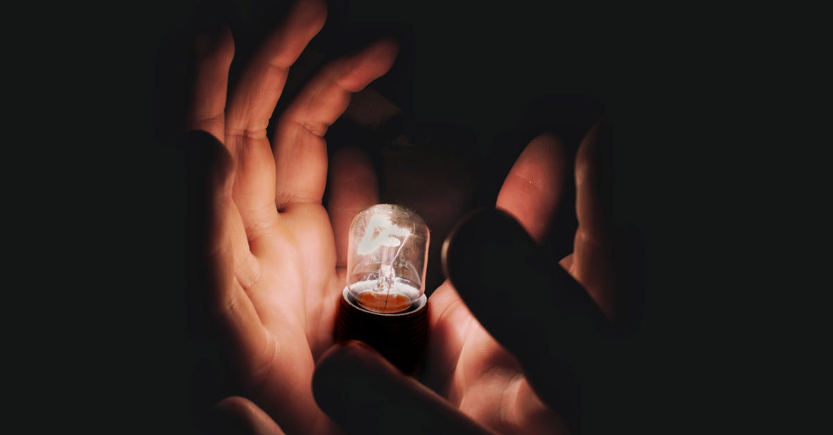 Why doesn't Nuketown show up in Black Ops 3? - Crop person holding burning lightbulb in darkness