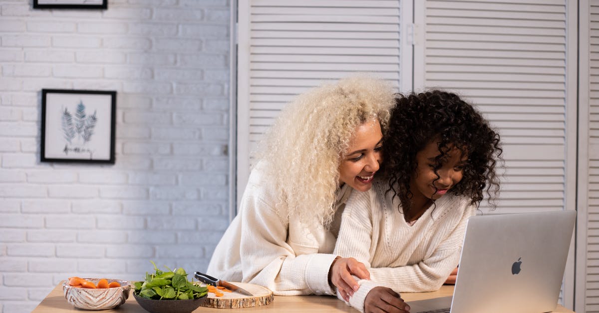 Why don't I have the HM Cut after defeating Misty? Is this a bug? - Smiling black mother and daughter browsing laptop at kitchen counter