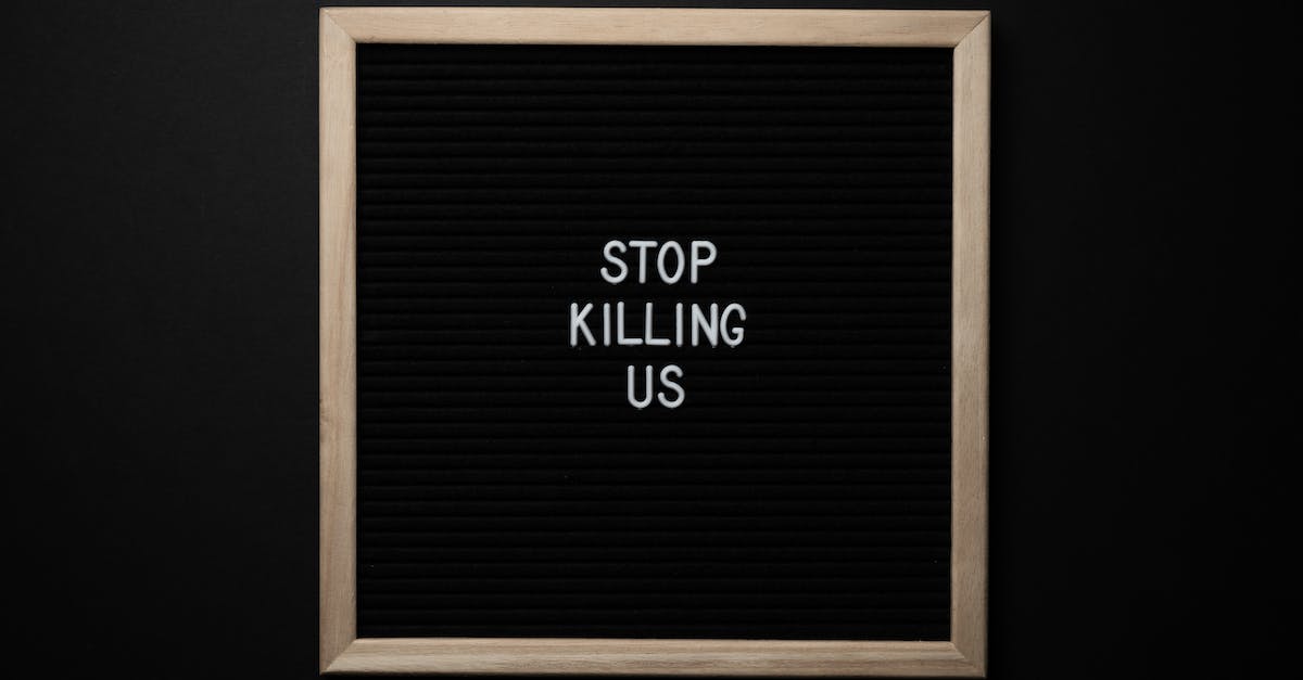 Why don't some demomen suffer from afterburn? - Top view of slogan Stop Killing Us on surface of square blackboard on black background Why don't some demomen suffer from afterburn? - Top view of slogan Stop Killing Us on surface of square blackboard on black background
