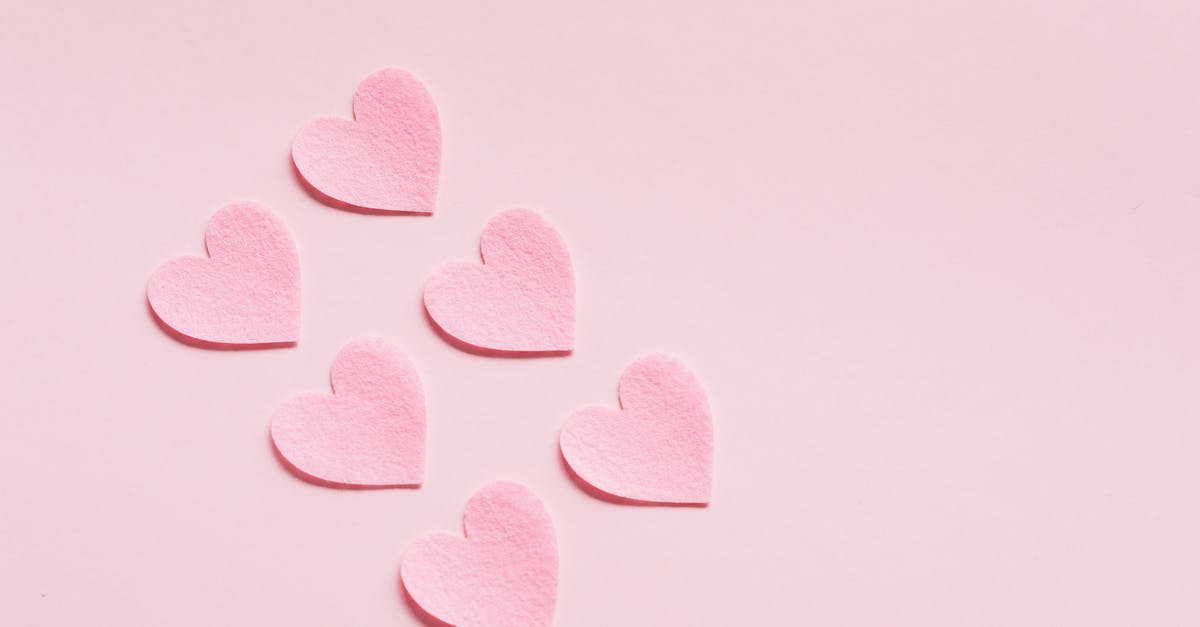 Why I cannot craft premium versions of some cards? - From above of composition made with heart shaped papers cutout of rough uneven pink cardboard placed diagonally on light pink background