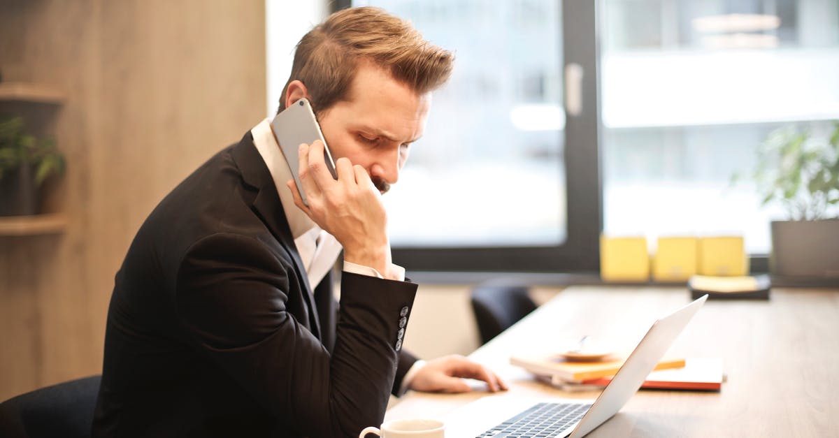 Why is Call Of Duty Modern Warfare 2 failing to install? - Man Having a Phone Call In-front of a Laptop Why is Call Of Duty Modern Warfare 2 failing to install? - Man Having a Phone Call In-front of a Laptop