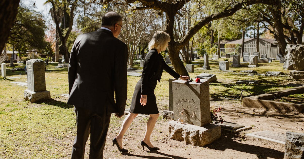 Why is Cybil with Harry in the graveyard after you beat Silent Hill? - A Couple Standing Near the Grave Stone