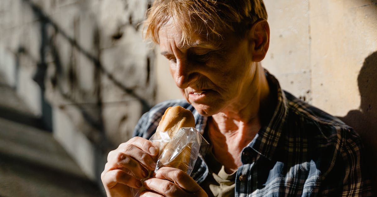 Why is hunger is not depleting on my server? - Close-up Photo of a Hungry Homeless Elderly Woman eating Sandwich 