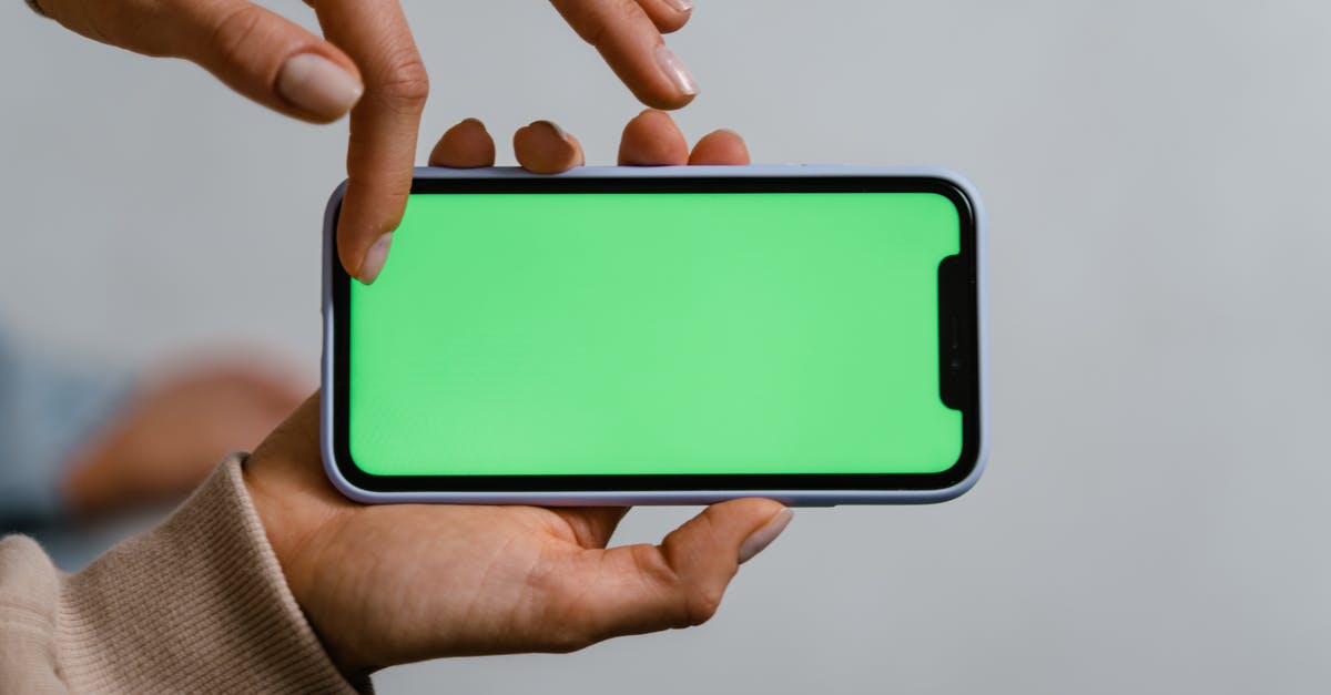 Why is Kaine glowing with a green aura? - Person Holding Blue and White Smartphone Why is Kaine glowing with a green aura? - Person Holding Blue and White Smartphone