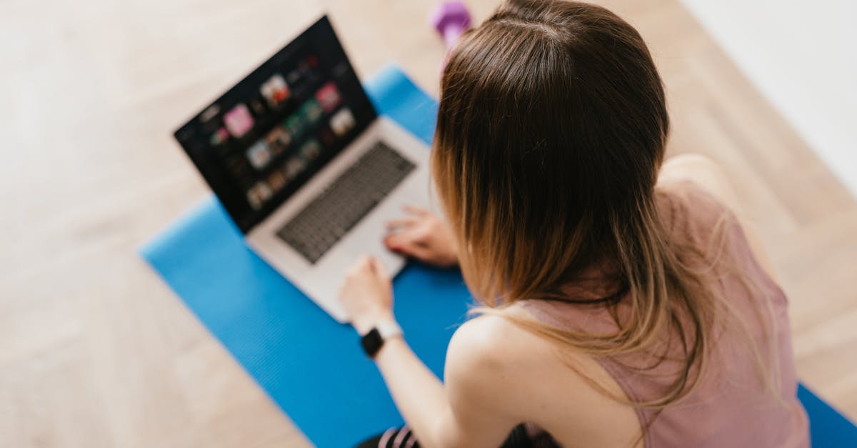 Why is Microsoft selling physical media games for Series S? - Woman sitting on mat and surfing internet on laptop