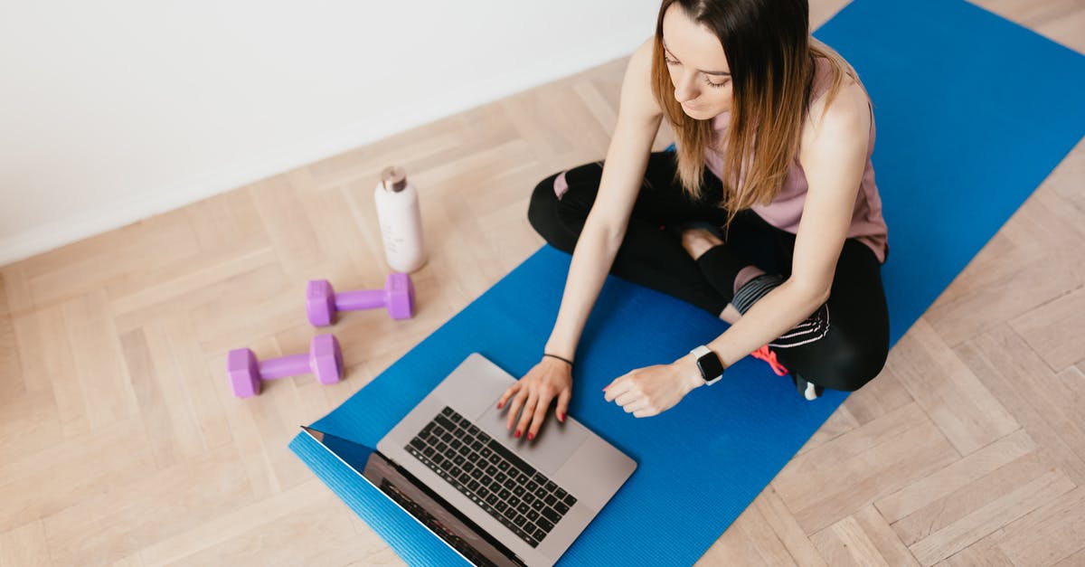 Why is Microsoft selling physical media games for Series S? - Young woman with laptop sitting on yoga mat