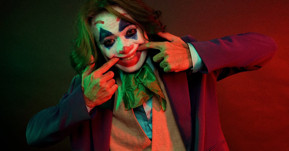 Why is my character invisible? - Dramatic male clown with painted face grimacing smile pulling mouth with hands while looking at camera