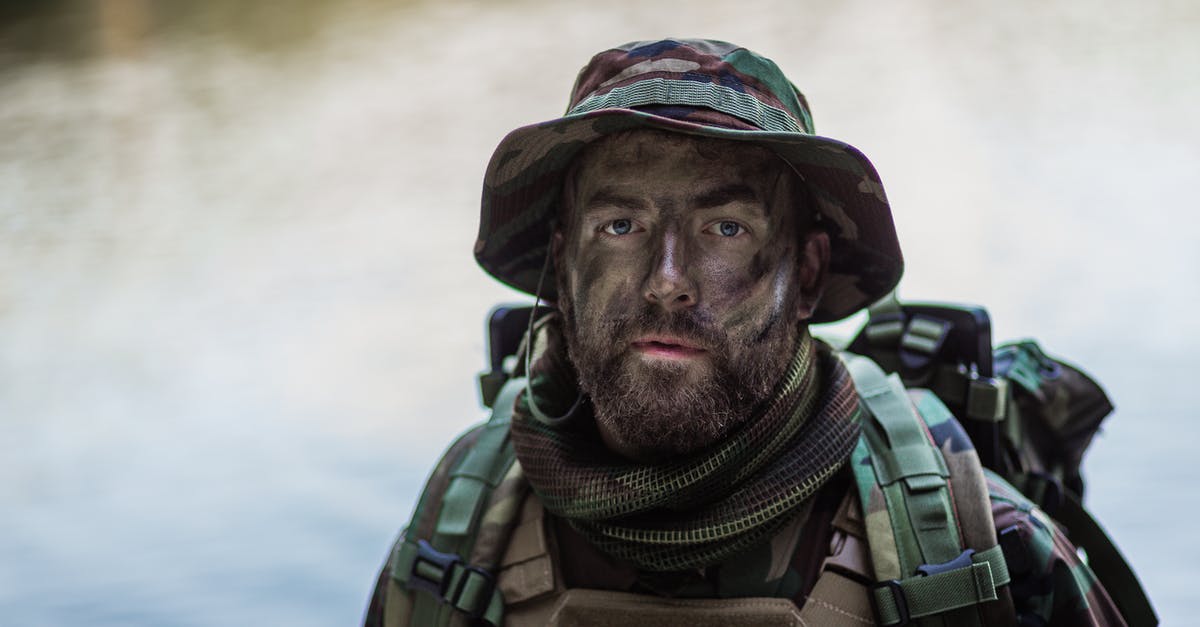 Why is my soldier breathing heavily after running? - Military Man in Camouflage and Painted Face Why is my soldier breathing heavily after running? - Military Man in Camouflage and Painted Face