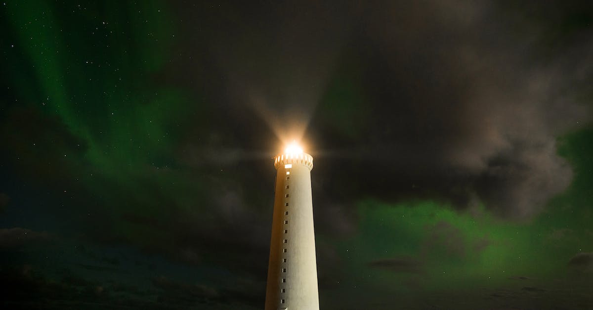 Why is the Dark Aurora full of railways and electric towers? - Lighthouse tower in cloudy night