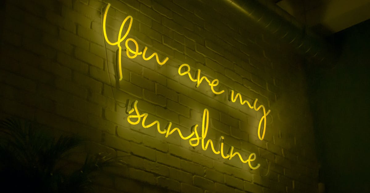 Why is there a yellow light on my Wii? - From below of illuminated signboard You are my sunshine with yellow neon light on white wall in dark room