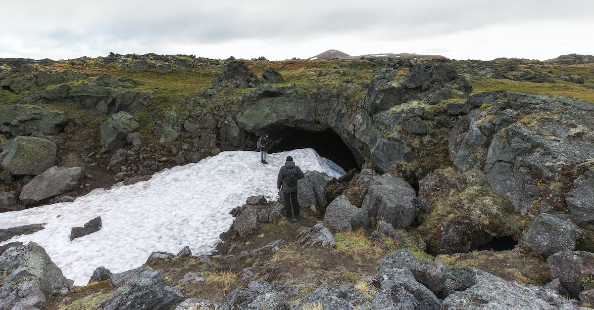 Why is there is a human in cave on my embark area? - People Standing Near a Cave
