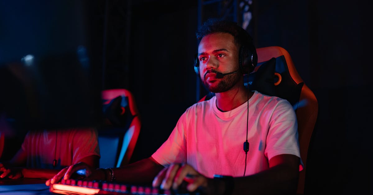 Why is Wifi seen as bad for online gaming - Photograph of a Man in a White Shirt Playing on a Computer Why is Wifi seen as bad for online gaming - Photograph of a Man in a White Shirt Playing on a Computer