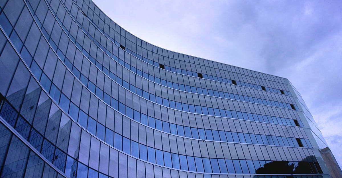 Why isn't Downtown Cab Company making any money? - Fish Eye View Photo of Glass High Story Building over White Cloudy Sky during Daytime