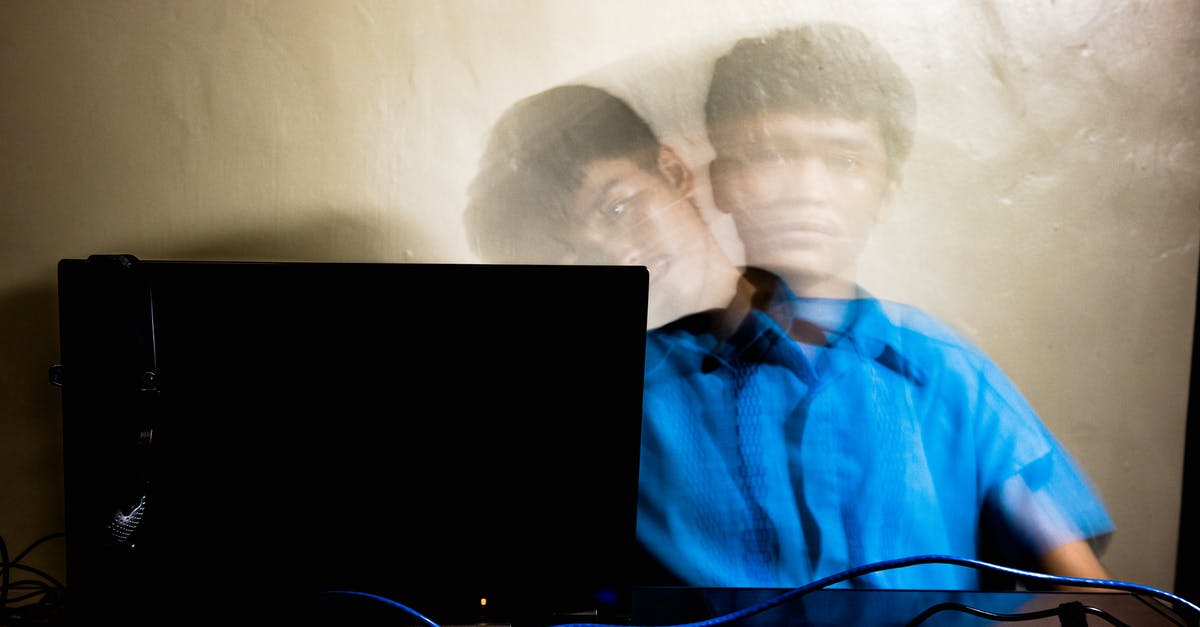 Why isn't this wiring working? - Long exposure of young Asian guy in blue t shirt sitting near laptop against yellow wall and bending aside