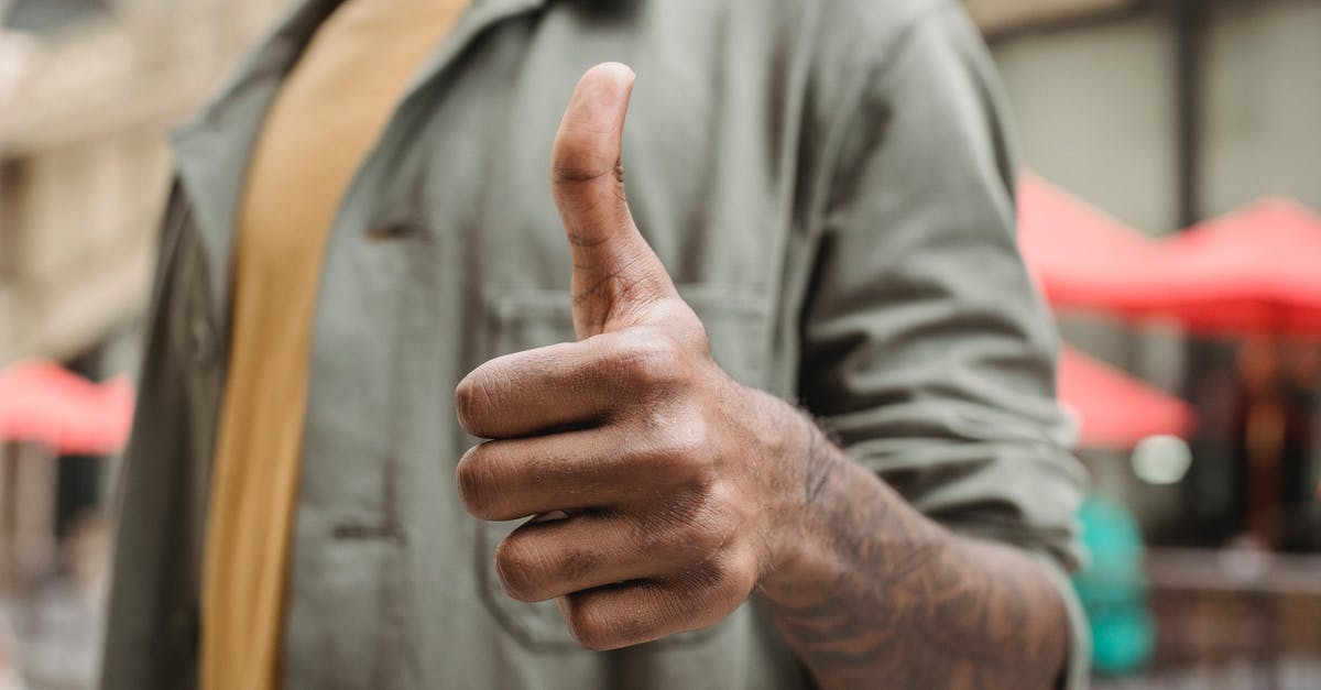 Why my games doesnt appear like it runs under 60 fps? - Crop faceless young black male in casual outfit standing on city street and showing thumb up gesture Why my games doesnt appear like it runs under 60 fps? - Crop faceless young black male in casual outfit standing on city street and showing thumb up gesture