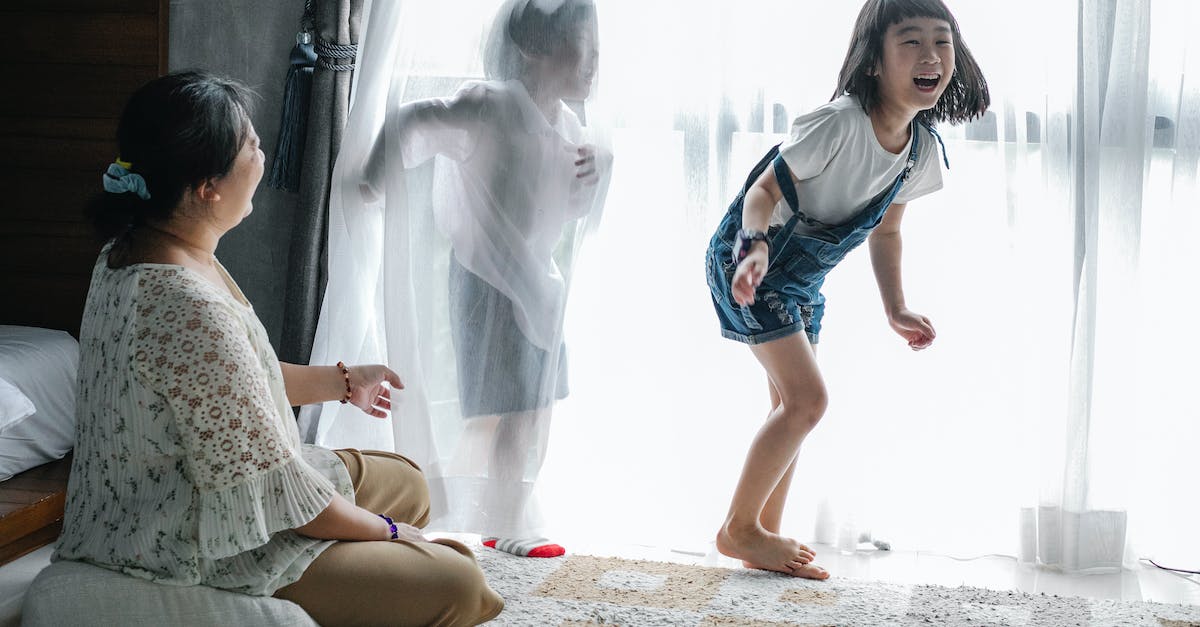 Why my mom and I can't play together, but not on a mini game server [closed] - Mother sitting on floor and playing with kids near big window in light room