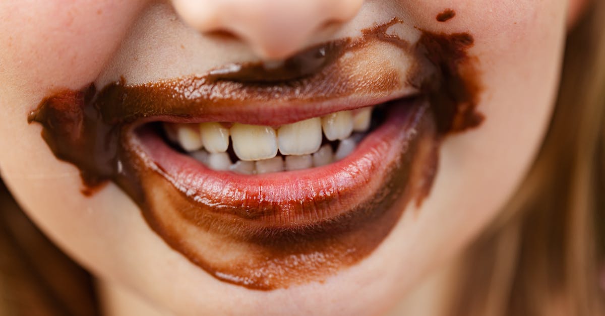 Why no sweet tooth [duplicate] - Close-up of Smiling Child Mouth in Chocolate