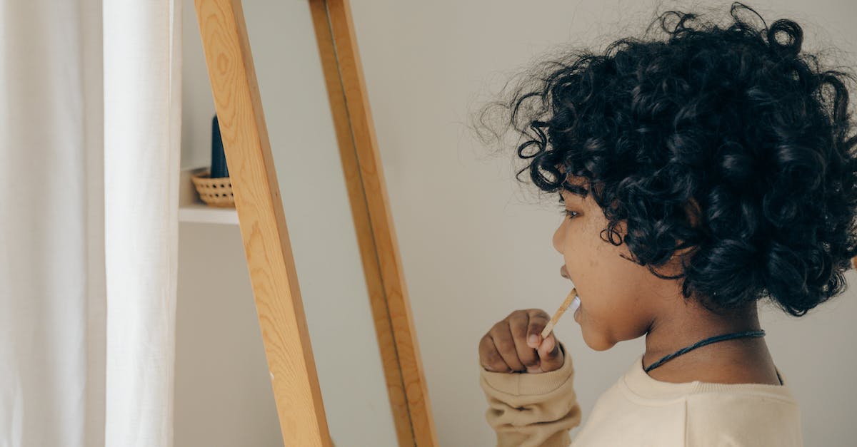 Why no sweet tooth [duplicate] - Ethnic kid brushing teeth opposite mirror