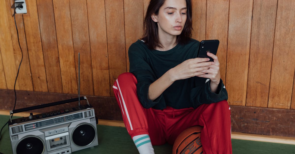 Why use the existing radio tower? - Woman Sitting on the Floor Using a Cellphone