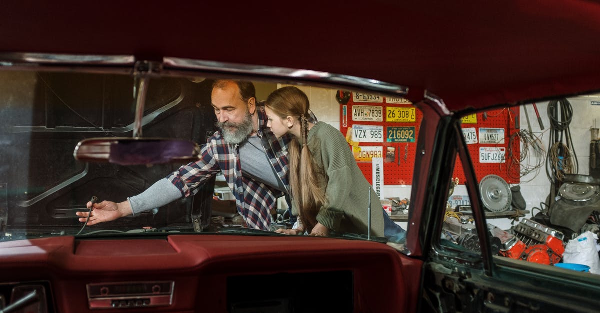 Why wasn't my car saved in Trevor's garage? - Man in Brown Coat Sitting on Red Car