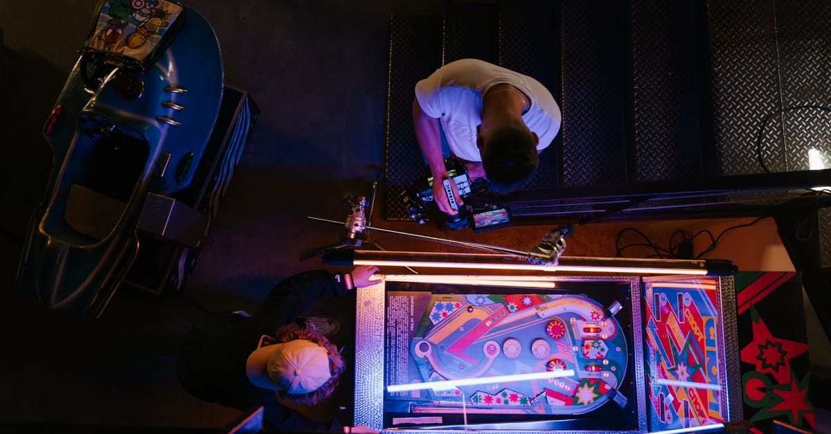 Why were arcade machines so big? - Man in White T-shirt Playing Arcade Game Why were arcade machines so big? - Man in White T-shirt Playing Arcade Game