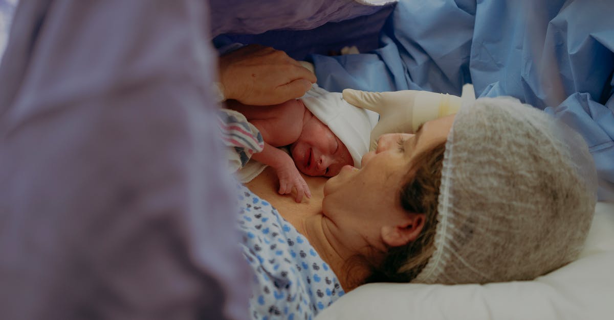 Why won't 4 women give birth? [duplicate] - Woman Holding her Newborn after Giving Birth