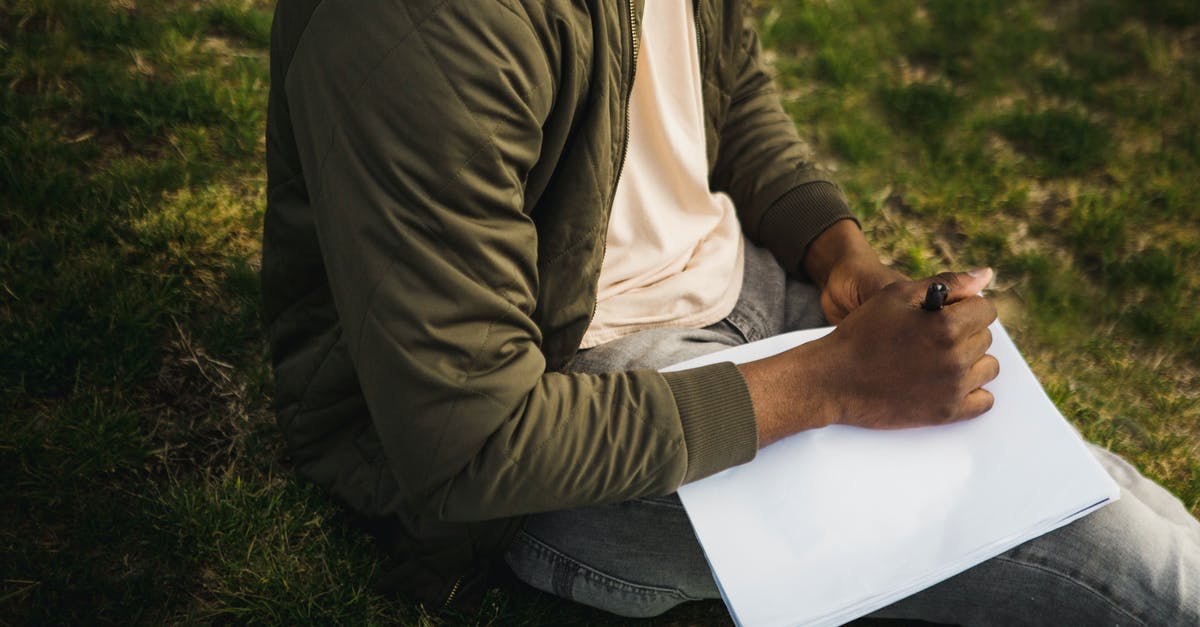 Why won't the End Portal I built in creative work? - From above of crop African American male artist in casual clothes sitting on grass in park with clean sketch album and pen