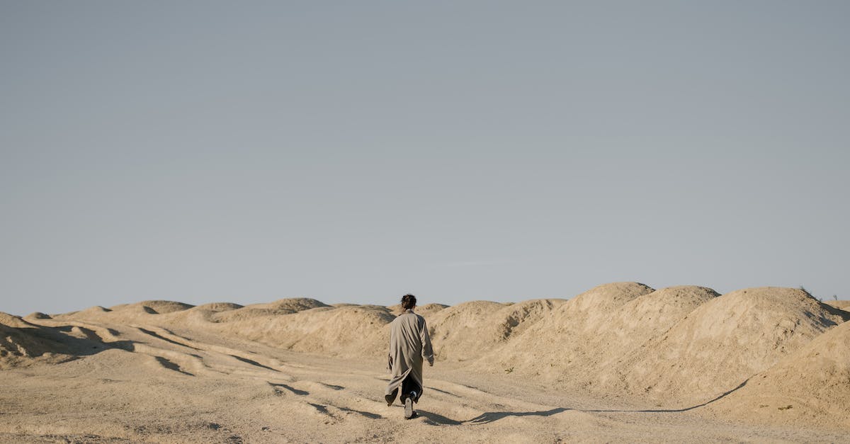 Why won't the Sloan quarry workers move back into Quarry Junction? - Man in Gray Jacket Walking on Brown Sand Why won't the Sloan quarry workers move back into Quarry Junction? - Man in Gray Jacket Walking on Brown Sand