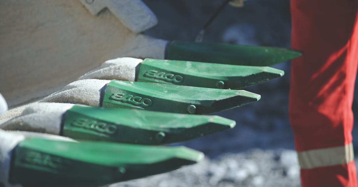 Why won't the Sloan quarry workers move back into Quarry Junction? - Crop person checking crown teeth of bucket front loader Why won't the Sloan quarry workers move back into Quarry Junction? - Crop person checking crown teeth of bucket front loader