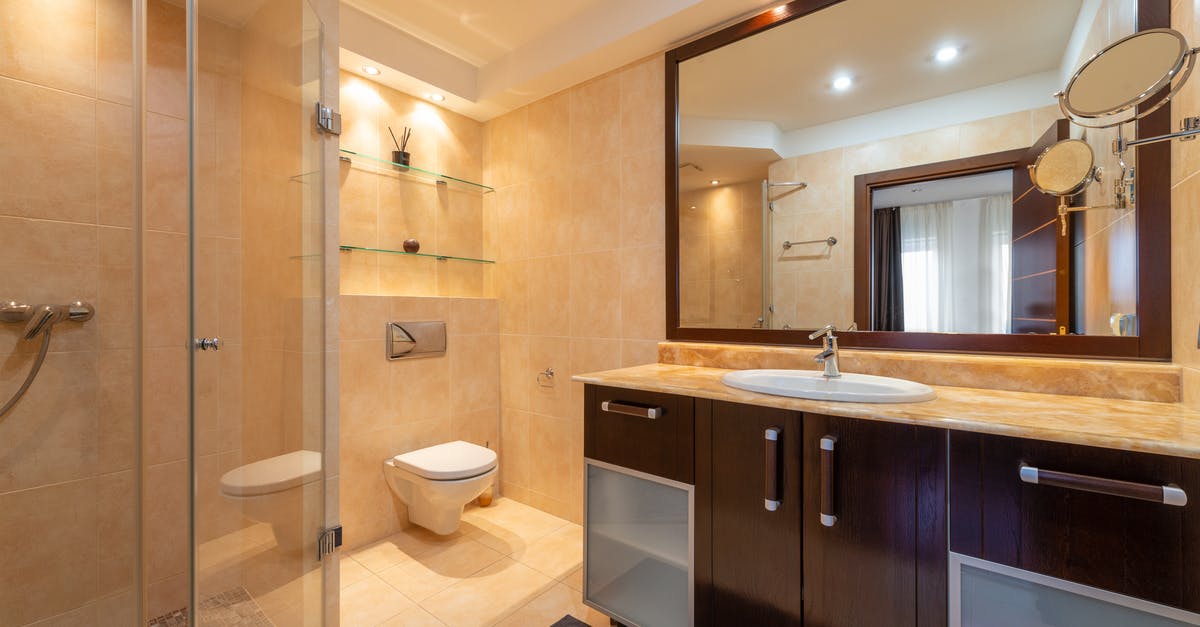 Why would a Pokemon have the incense glow? - Shower room against toilet bowl and cabinet with washbasin under mirrors illuminated by shiny lamps in modern house Why would a Pokemon have the incense glow? - Shower room against toilet bowl and cabinet with washbasin under mirrors illuminated by shiny lamps in modern house