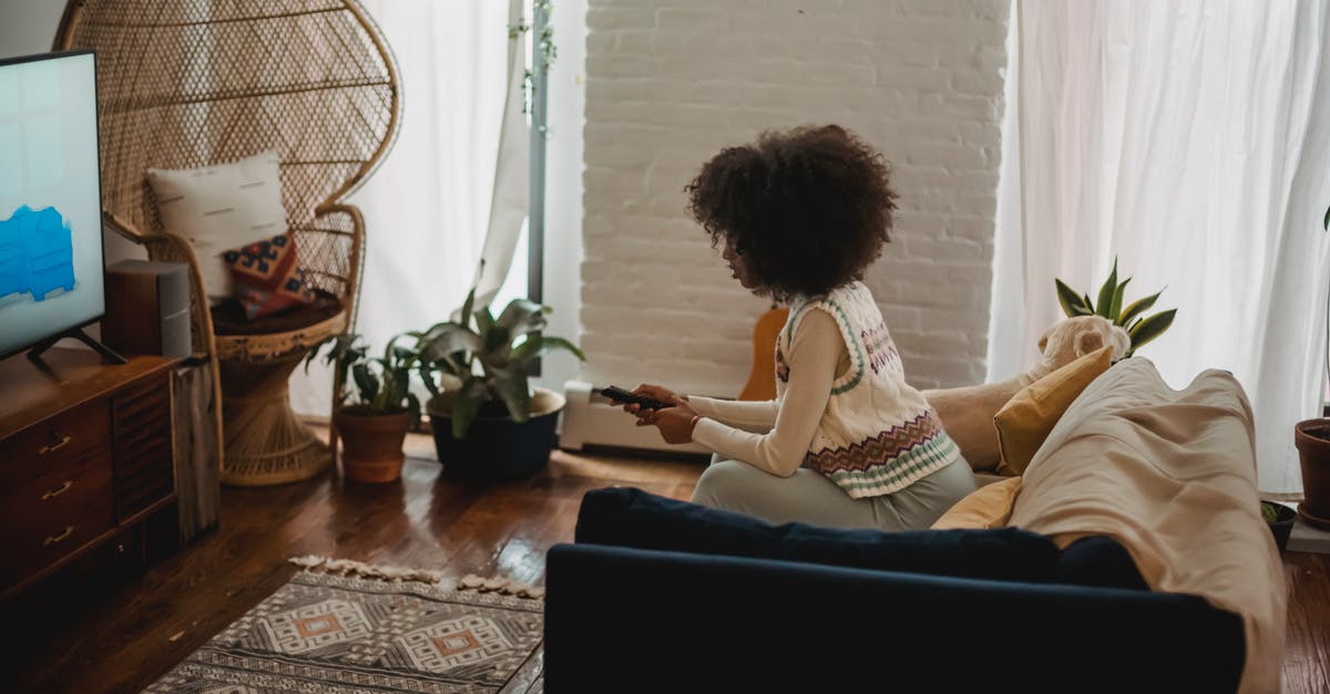 Wii remotes disconnect as soon as I enter a channel - Focused young ethnic woman with remote controller watching TV at home Wii remotes disconnect as soon as I enter a channel - Focused young ethnic woman with remote controller watching TV at home