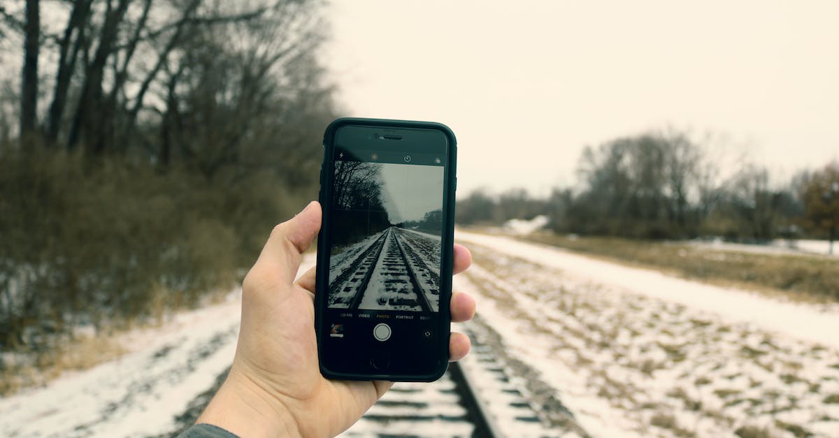 Wii U HDMI to DVI-D displays snow - Person Holding Iphone Taking Photo of Train Rails Wii U HDMI to DVI-D displays snow - Person Holding Iphone Taking Photo of Train Rails