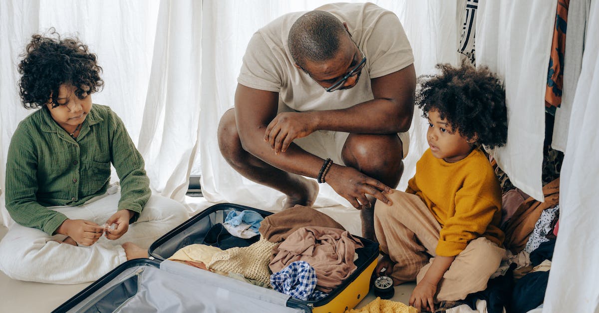 Will a little sister leave you if you kill a big daddy? - African American father in eyewear with sad kids with curly hair sitting near opened suitcase Will a little sister leave you if you kill a big daddy? - African American father in eyewear with sad kids with curly hair sitting near opened suitcase