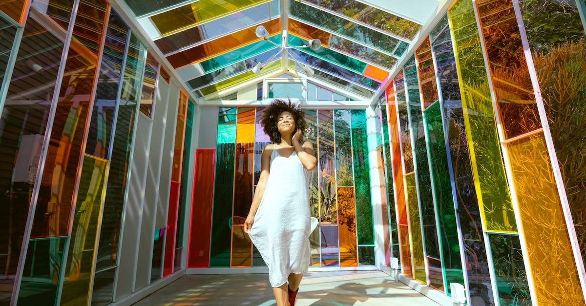 Will Boots of Swiftness + Tenacity be a good item for Off-Tank champions? - Photo of Smiling Woman in White Dress and Brown Boots Posing in Multicolored Glass House