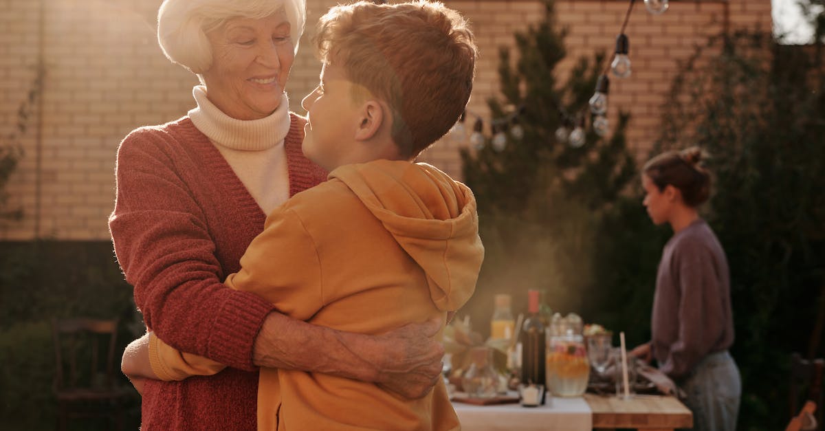 Will Clash of Clans overwrite my account, if my son has his own account on my old iPhone? - Elderly Woman Hugging Her Grandson Will Clash of Clans overwrite my account, if my son has his own account on my old iPhone? - Elderly Woman Hugging Her Grandson