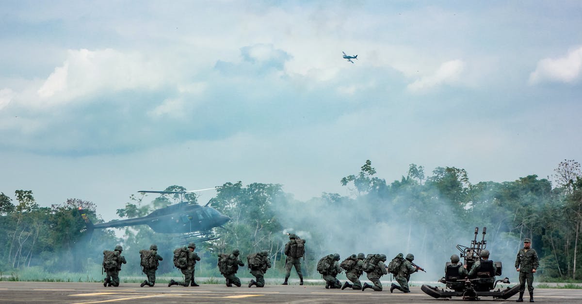 Will I earn bonuses by accomplishing a mission remaining unseen? - Unrecognizable soldiers with infantry weapons accomplishing military mission near helicopter
