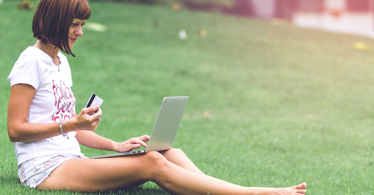 Will I earn Nintendo Points for digital purchases outside the eShop? - Woman Holding Card With Macbook Air on Lap Will I earn Nintendo Points for digital purchases outside the eShop? - Woman Holding Card With Macbook Air on Lap