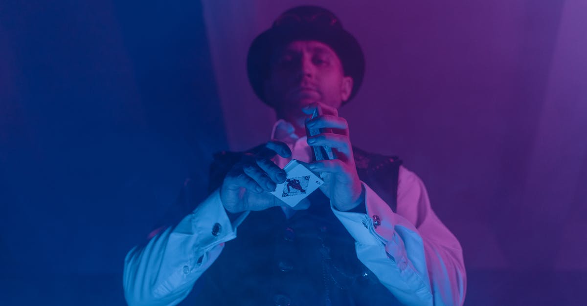 Will multiplayer games in Magic 2015 unlock cards? - Man in White Shirt and Black Hat Holding Deck of Cards